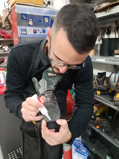 Ismael fixing a hiking boot. Photo © Karethe Linaae